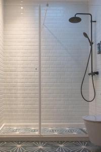 a shower with a glass door in a bathroom at Viva! Farmhouse in Monsaraz