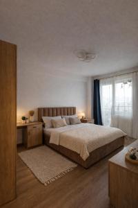 a bedroom with a large bed and a window at Cozy space in Iaşi