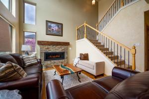 a living room with a couch and a fireplace at Snowcrest C304Ski Getaway Hot Tub & Theater Room in Eden