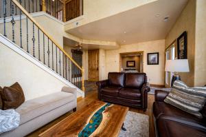 a living room with a couch and a staircase at Snowcrest C304Ski Getaway Hot Tub & Theater Room in Eden +77 photos