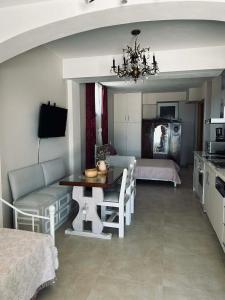 a kitchen and living room with a table and chairs at Sunrise & Sunset apartments in Monemvasia