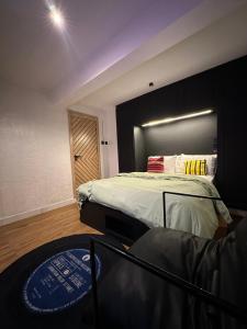 a bedroom with a bed with a mirror and a chair at The Hive Apartments - The Forge Unit in Lagos