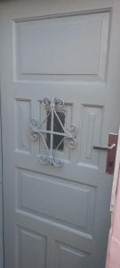 a white door with a metal design on it at Rio Private Budget Suite & Easy Transport Access in Rio de Janeiro