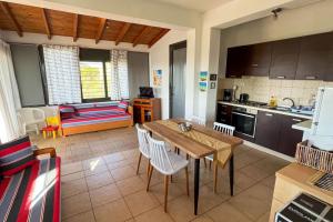 a kitchen and living room with a table and chairs at Villa Maty in Karianí