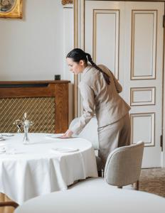 a woman standing at a table in a room at Palé Hall Hotel & Spa in Bala