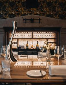 a table with wine bottles and glasses on it at Palé Hall Hotel & Spa in Bala