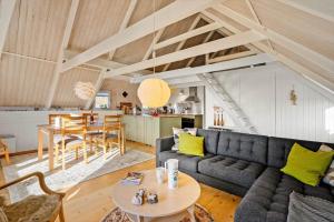 a living room with a couch and a table at 2289-Ringkobing-Nordso-Ferievej-21 in Klegod