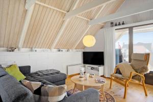 a living room with a couch and a table at 2289-Ringkobing-Nordso-Ferievej-21 in Klegod