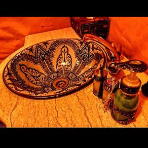 a sink with a design on it on a table at Azadic luxury tents in Merzouga