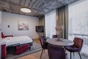 a room with a bed and a table and chairs at Sakalo kopa in Palanga +67 photos