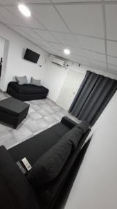 a room with two beds and a couch at Sisters Place in Guaymallen