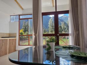 a kitchen with a glass table and a large window at Florez de la Villa Apartments & Suites in Cusco