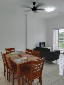 a living room with a table and chairs and a couch at IJM Suria Homestay in Sandakan +43 photos
