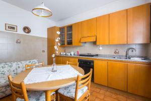 a kitchen with a table and chairs and a kitchen with a sink at Il Melograno, appartamento privato in Cavriago +13 photos