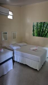 a room with two beds in a room at Pousada Casa Rosa in Itacaré +17 photos