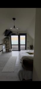 a bedroom with a bed and a large window at RestOnTheLake in Esztergom