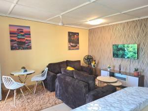 a living room with a couch and a table and chairs at Janari Homes in Diani Beach