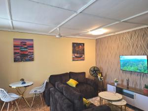 a living room with a couch and a table at Janari Homes in Diani Beach
