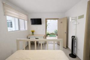 a bedroom with a bed and a table and a television at Casa Mompa in Bucaramanga