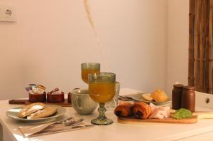 a table with two glasses of orange juice and croissants at HA Hotel TESORO MEDITERRANEO in Almuñécar +13 photos