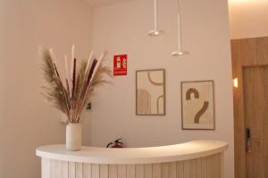 a bathroom with a vase with a plant in it at HA Hotel TESORO MEDITERRANEO in Almuñécar
