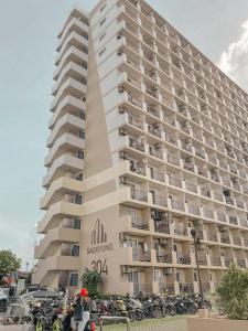 a large building with motorcycles parked in front of it at Gold-Themed Condo with Balcony and FREE Pool Access in Suba