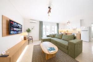 a living room with a couch and a table at Olive Aura in Mytilene