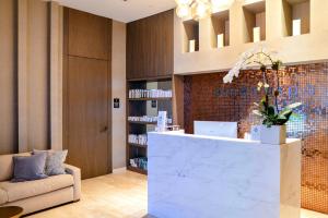 a lobby with a reception desk and a couch at Oceanfront Escape - Rooftop Pool & Beach Access in Hollywood