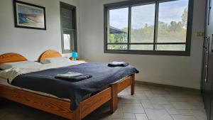 a bedroom with a bed with two towels on it at Holiday home in Galilee in Sheʼar Yashuv