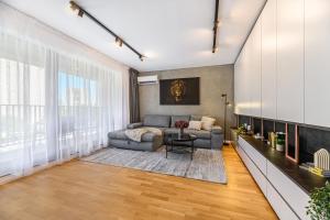 a living room with a couch and a table at KOA - Signature Collection in Braşov