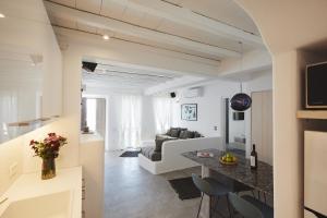 a kitchen and living room with white walls and ceilings at Mykonos Dunes Villas in Mikonos