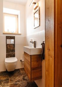 a bathroom with a sink and a toilet at Bauernhofurlaub Eggcellence in Teisendorf +30 photos