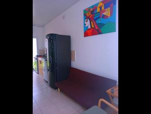 a living room with a couch and a refrigerator at Casa de Milo in Ahuachapán