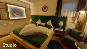 a bedroom with a bed with a teddy bear on it at Alpineas in Leutasch +29 photos