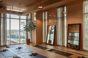 a room with yoga mats in front of a large window at ROOST Rainey in Austin