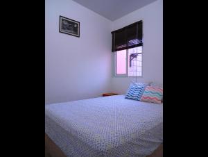 a bedroom with a bed and a window at Casa de Milo in Ahuachapán