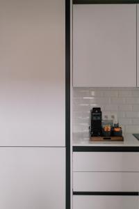 a kitchen with a counter top with a microwave at A Place Antwerp - Boutique Suites & Flats - Schuttershofstraat 1 in Antwerp