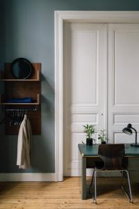 a room with a door with a desk and a window at A Place Antwerp - Boutique Suites & Flats - Schuttershofstraat 1 in Antwerp