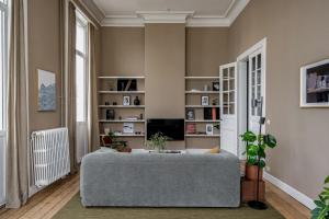 a living room with a couch and a tv at A Place Antwerp - Boutique Suites & Flats - Schuttershofstraat 1 in Antwerp