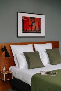 a bedroom with two beds and a picture on the wall at A Place Antwerp - Boutique Suites & Flats - Schuttershofstraat 1 in Antwerp +56 photos