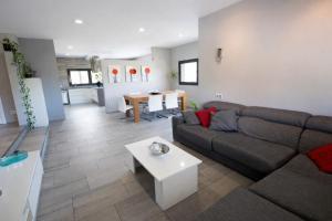 a living room with a couch and a table at Catalunya Casas Modern Marvel,15 min to Costa Brava beaches! in Sils