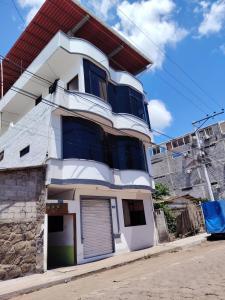 a white house with a red roof at Misha Home Nro 732 in Puerto Ayora