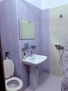 a bathroom with a sink and a toilet at Résidence ephrata in Cocody +18 photos