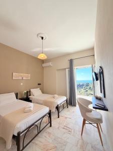 a hotel room with two beds and a window at Galini Seaview Kontogialos in Pelekas +120 photos