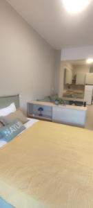 a large bedroom with two beds and a kitchen at Casa Oliva in Ermoupoli