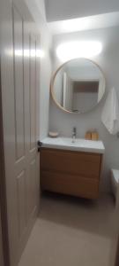 a bathroom with a sink and a mirror at Casa Oliva in Ermoupoli