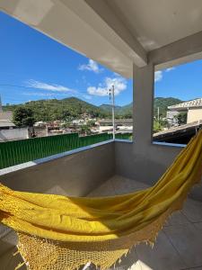 a hammock on a balcony with a view at Casa em itapema fácil acesso e bem localizada in Itapema