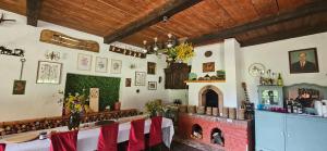a dining room with a table and a fireplace at Agroturystyka Stara Huta in Narol
