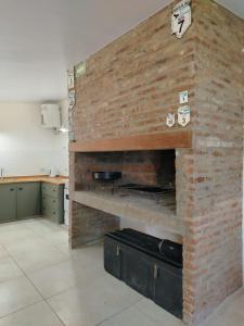 a brick wall in a kitchen with a fireplace at Refugio del sol Erezcano in Eréscano