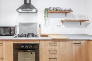 a kitchen with wooden cabinets and a stove top oven at Ca'n Tosca Jávea in Jávea +23 photos